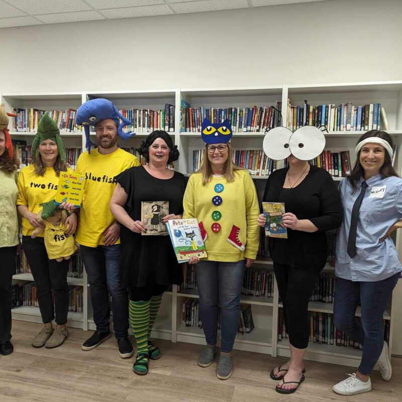 Group of teachers dressed up in the library